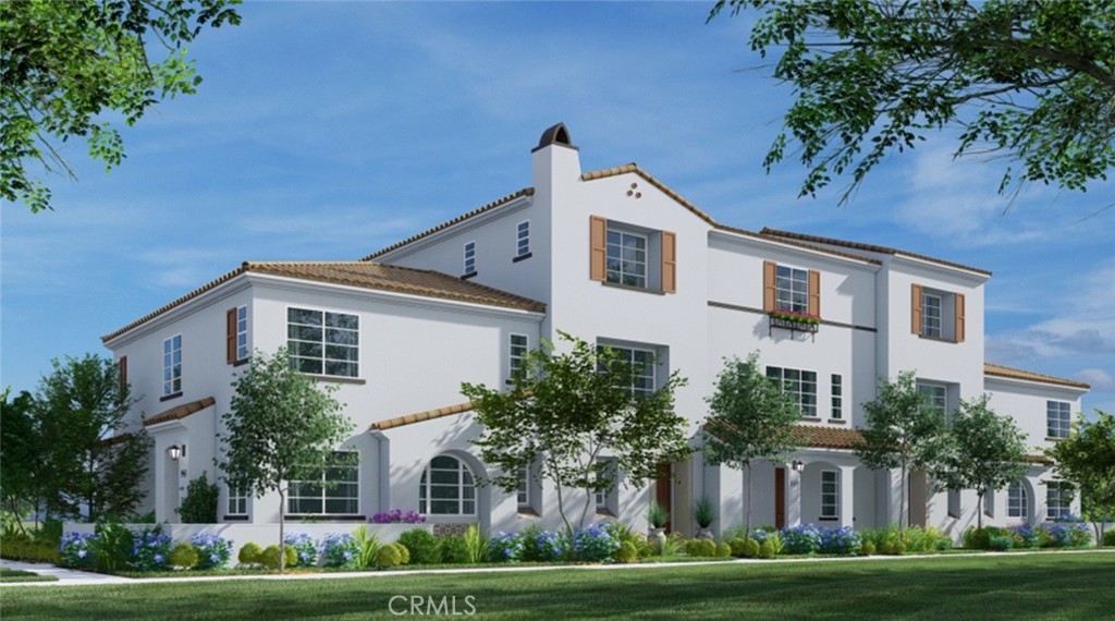 a front view of a house with a yard and trees