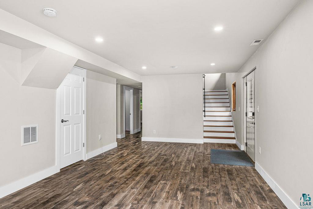 5025 Reid Road Duluth, MN 55803 - Photo 29 of 51 Spacious room featuring wood-finish flooring, recessed lighting, and light-toned walls