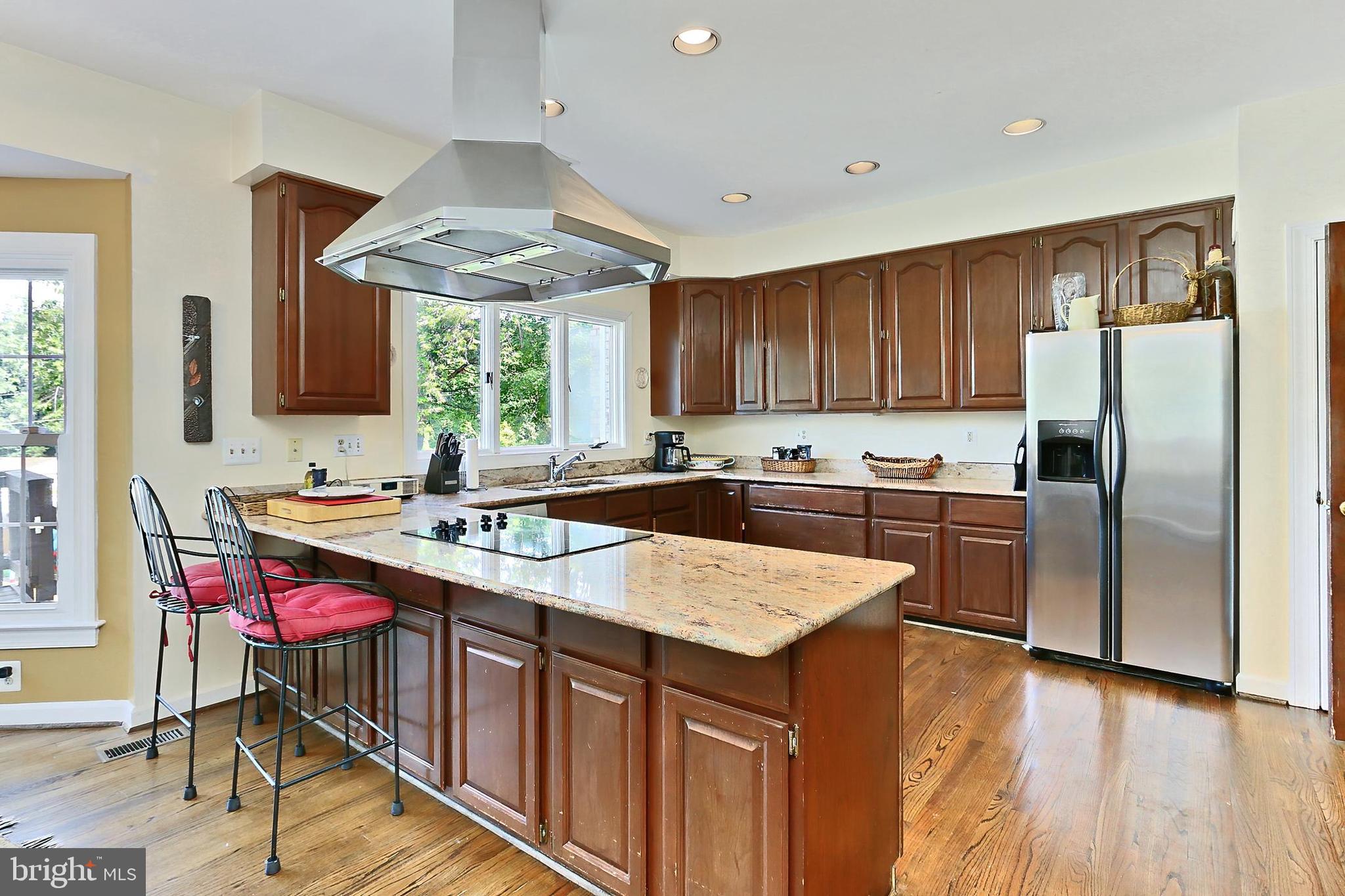 13310 Compton Road Clifton, VA 20124 - Photo 24 of 117 a kitchen with stainless steel appliances granite countertop a refrigerator a sink dishwasher a stove and white countertops with wooden floor