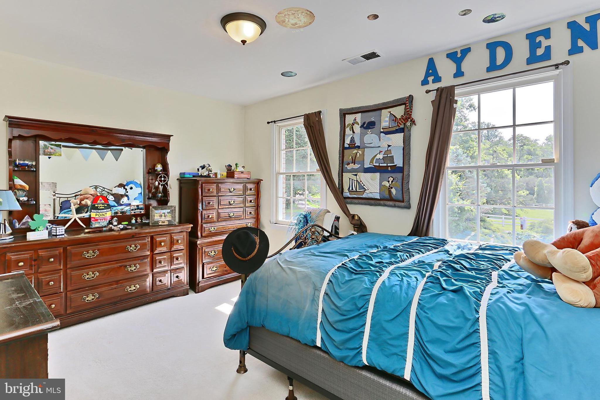 13310 Compton Road Clifton, VA 20124 - Photo 44 of 117 a bed sitting in a bedroom next to a window