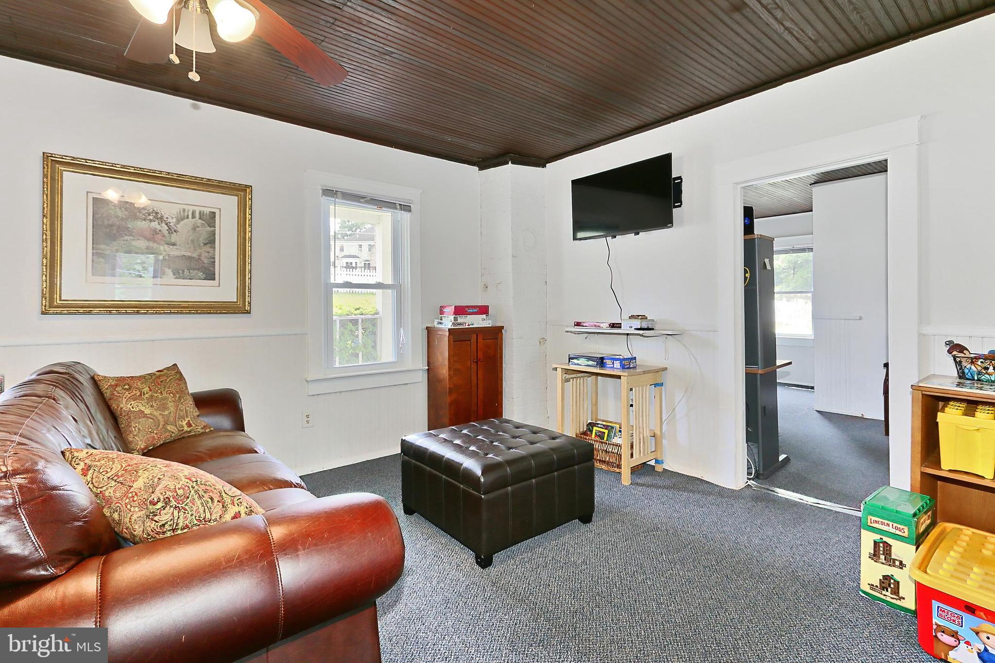 13310 Compton Road Clifton, VA 20124 - Photo 82 of 117 a living room with furniture and a flat screen tv