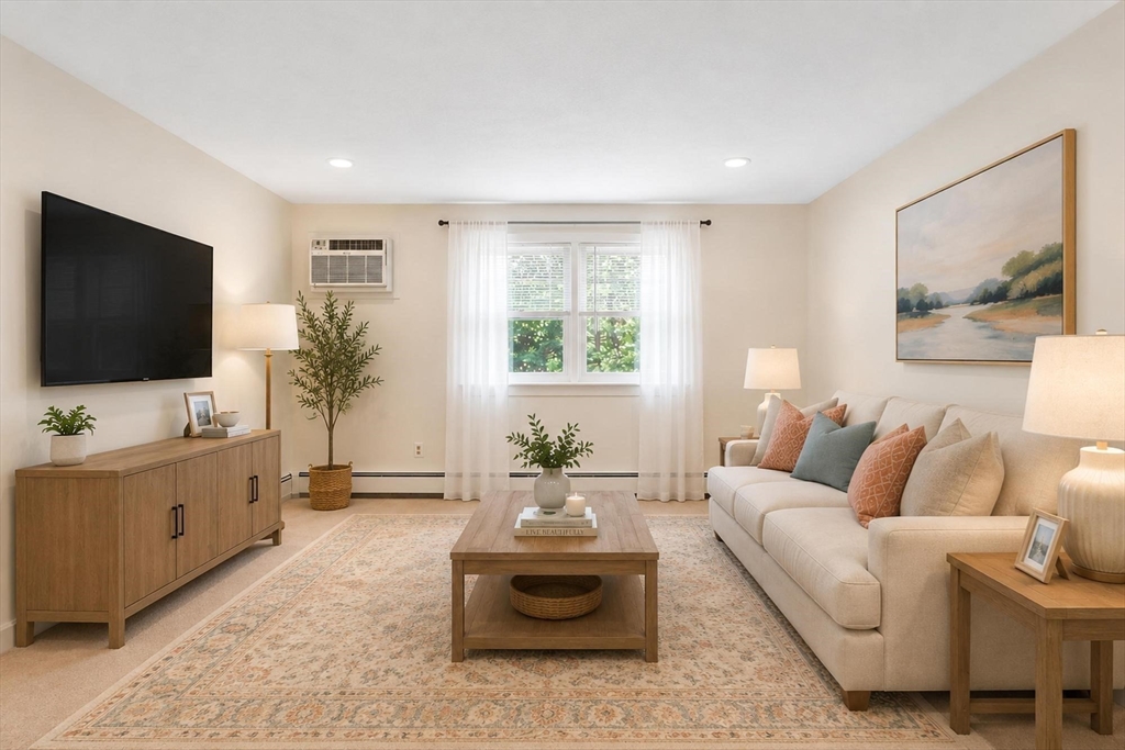 420 Great Road, Unit C1 Acton, MA 01720 - Photo 9 of 29 a living room with furniture and a flat screen tv