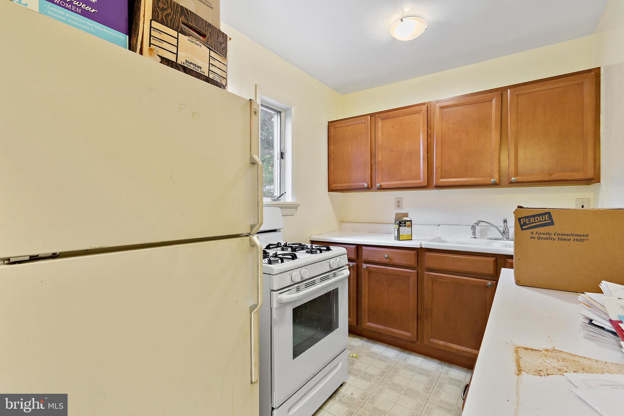 5913 Rolston Road Bethesda, MD 20817 - Photo 8 of 37 a kitchen with a sink stove and refrigerator