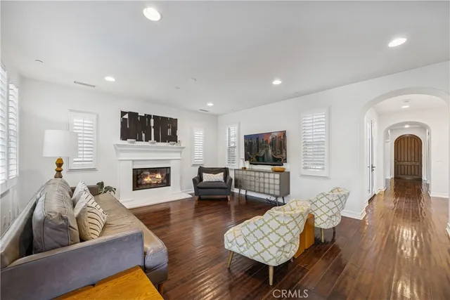 a living room with furniture fireplace and flat screen tv