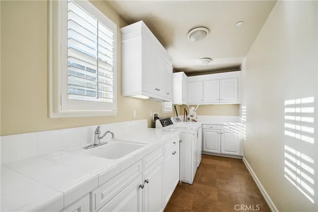 a kitchen with sink attached with living room