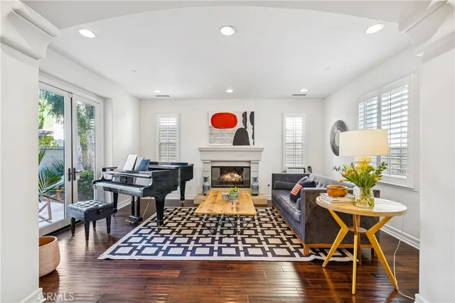 a living room with furniture a rug and a fireplace
