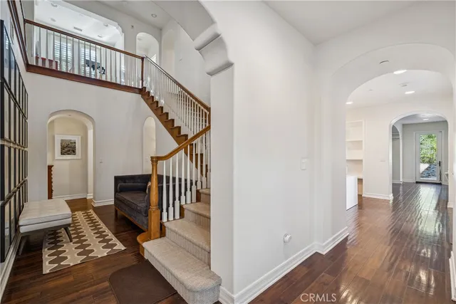 a view of front door with wooden floor and a rug