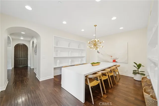 a dining room with furniture and wooden floor
