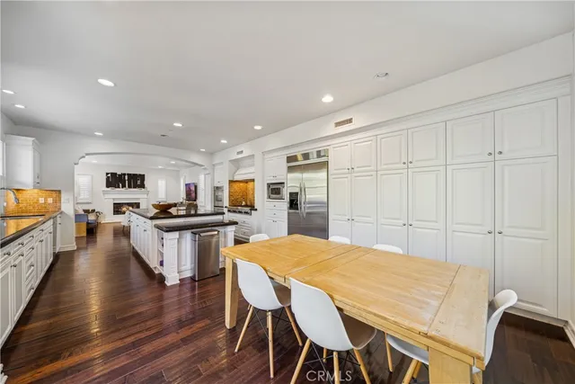 a large kitchen with a table and chairs