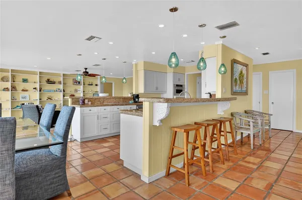 a large kitchen with a table and chairs