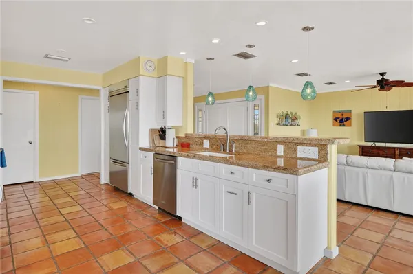 a kitchen with cabinets and chairs