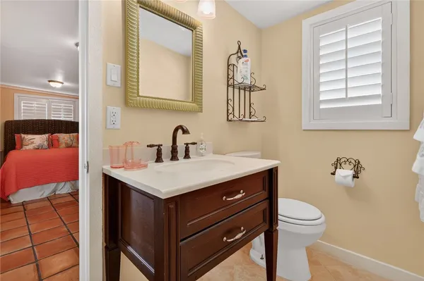 a bathroom with a sink toilet and mirror