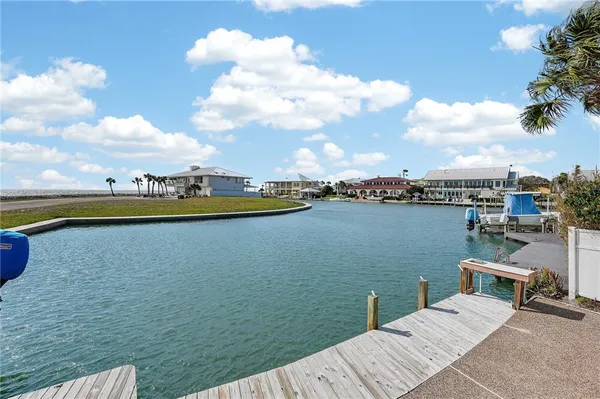 a view of a lake with lawn chairs
