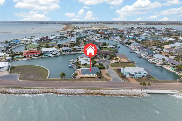 an aerial view of a house with a ocean