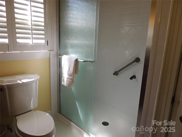 a white toilet sitting next to a bath tub