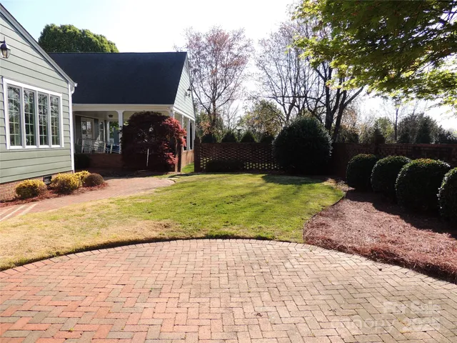 a view of a house with backyard and trees