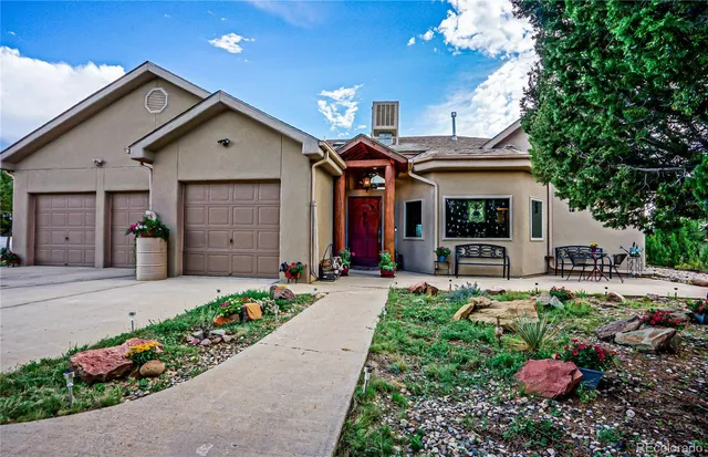 a front view of a house with a yard and a garage