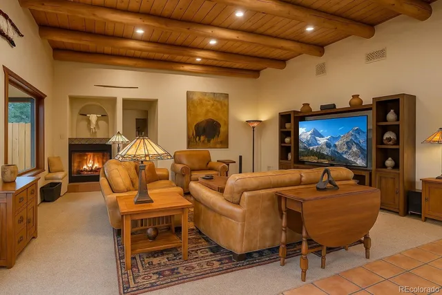 a living room with furniture a rug and a flat screen tv