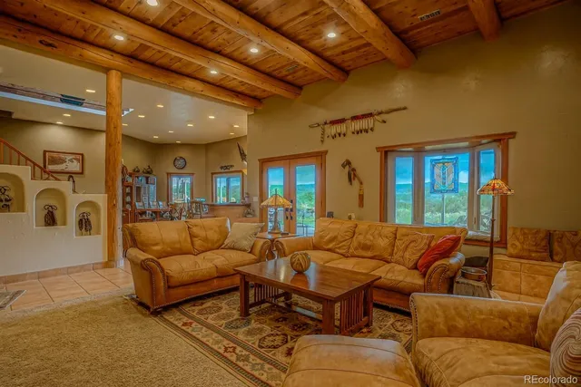 a living room with furniture ceiling fan and a rug