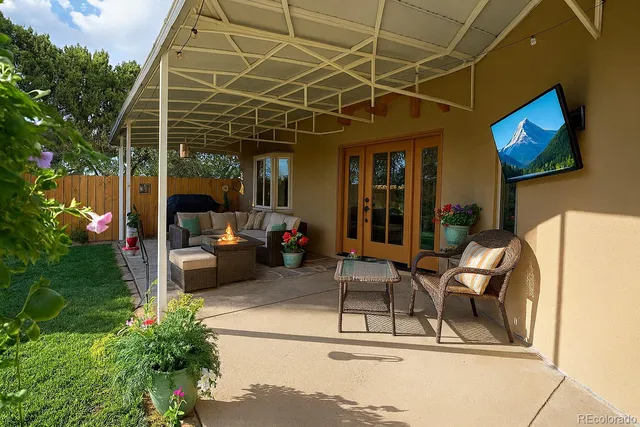a building outdoor space with patio furniture and potted plants