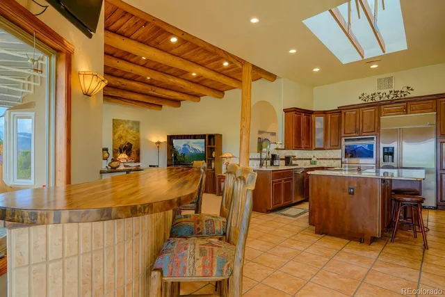 a very nice looking kitchen with a large counter space appliances and cabinets