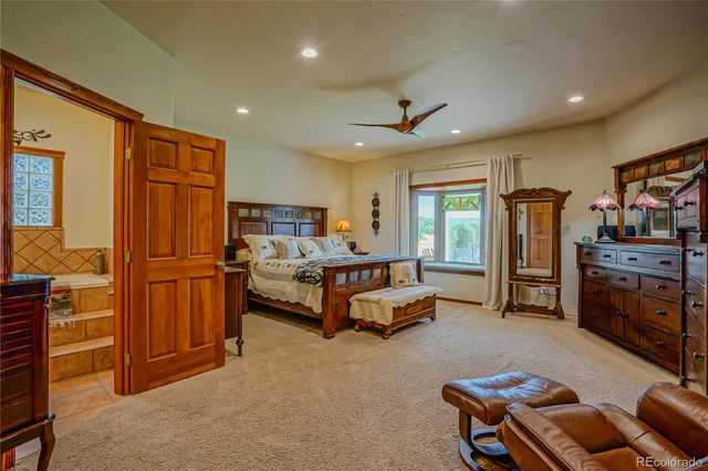 a spacious bedroom with a bed and furniture