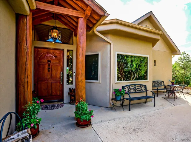 a view of a house with a porch and furniture