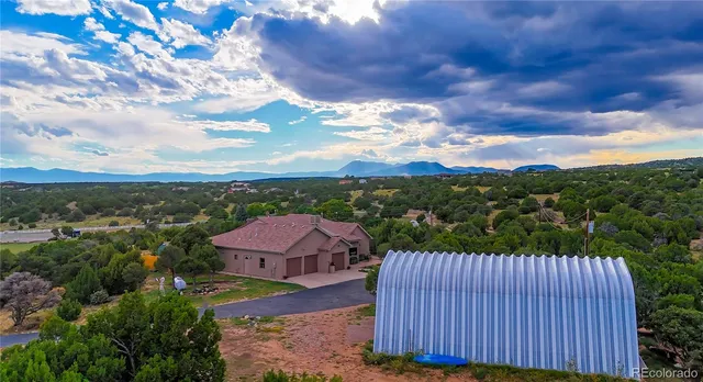 an aerial view of a house with a garden