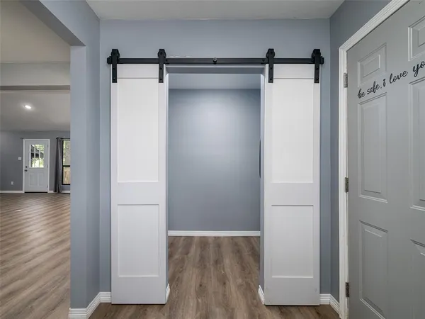 a view of walk in closet with wooden floor