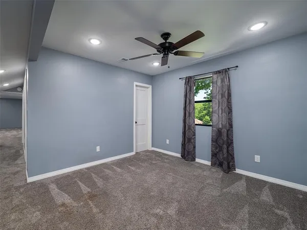 an empty room with windows and closet