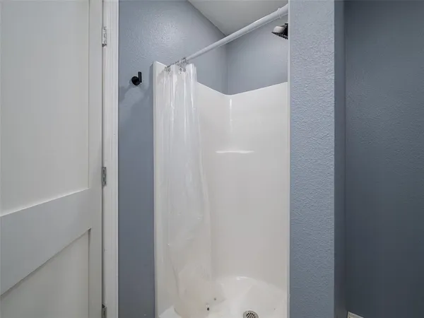 a bathroom with a glass shower door
