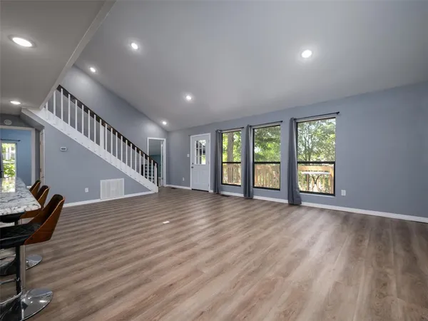 a view of an entryway with wooden floor