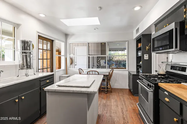 a kitchen with a sink stove and microwave