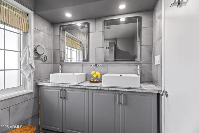 a bathroom with a sink a toilet and mirror