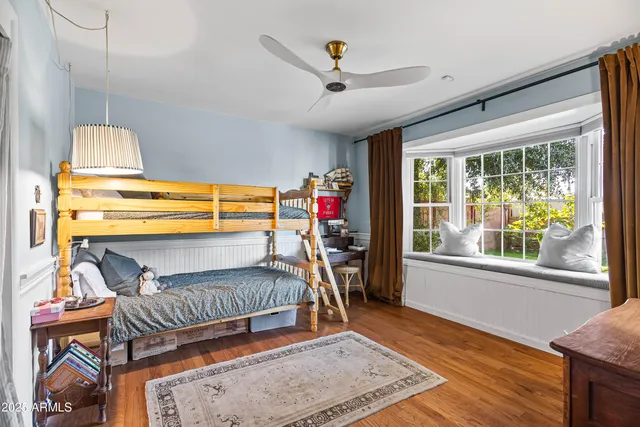 a living room with a bed furniture and a large window
