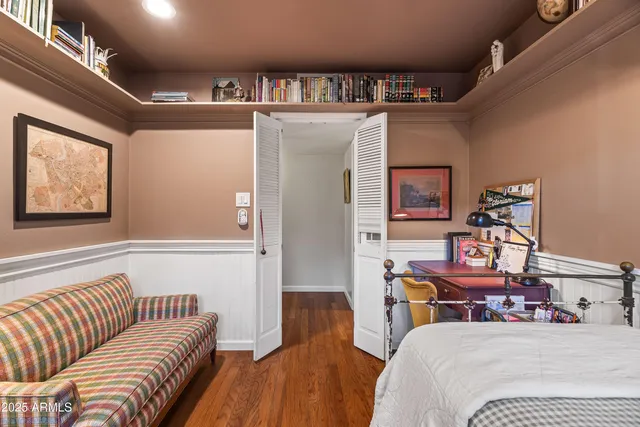 a bedroom with a bed furniture and a chandelier