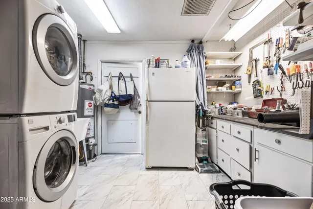 a kitchen with refrigerator a washer and dryer
