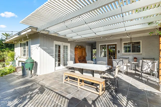 a living room with a table chairs and a barbeque
