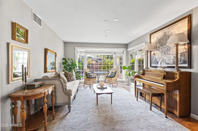 a living room with fireplace furniture and a large window