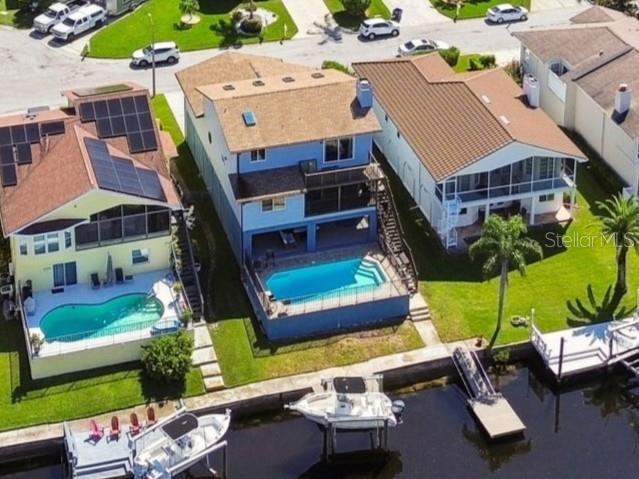 6241 Bayside Drive New Port Richey, FL 34652 - Photo 57 of 78 an aerial view of a house with a garden and swimming pool