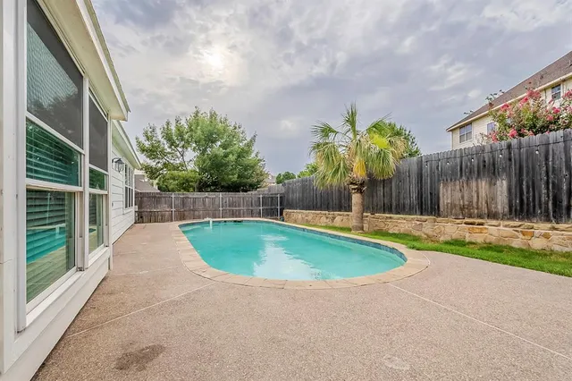 a swimming pool with outdoor seating and yard