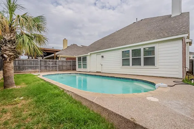 a view of a house with a swimming pool and a patio