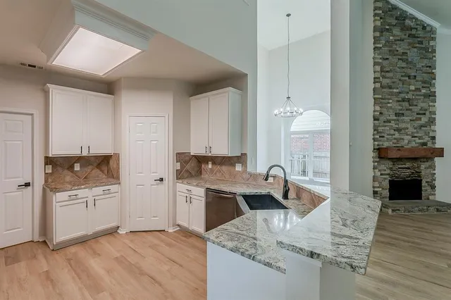 a kitchen with a sink stove and cabinets