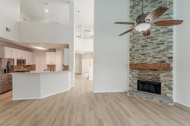 a view of a kitchen with cabinets and wooden floor