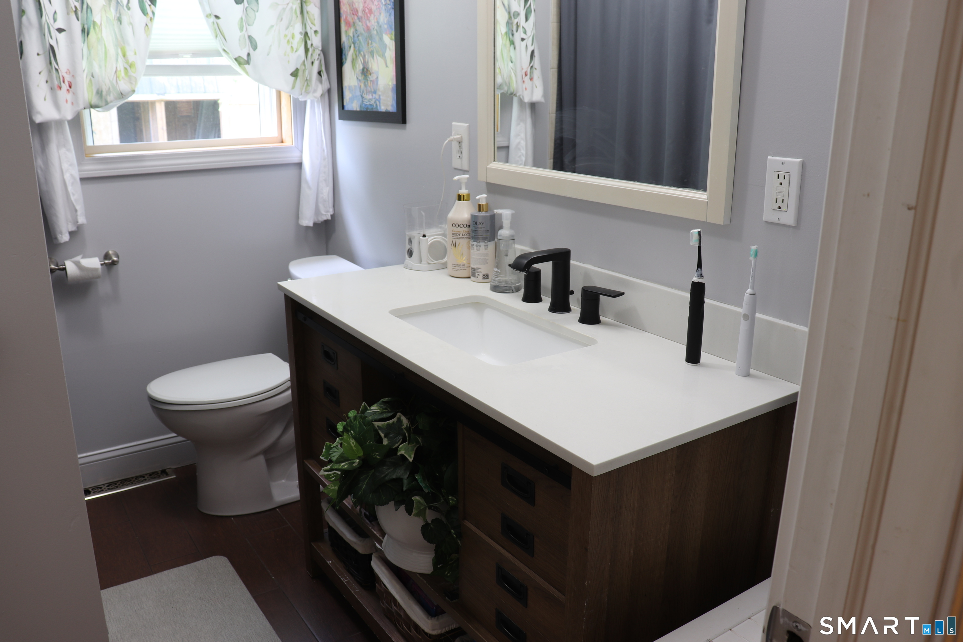 308 Abbe Road Enfield, CT 06082 - Photo 18 of 33 a bathroom with a sink a toilet and a mirror