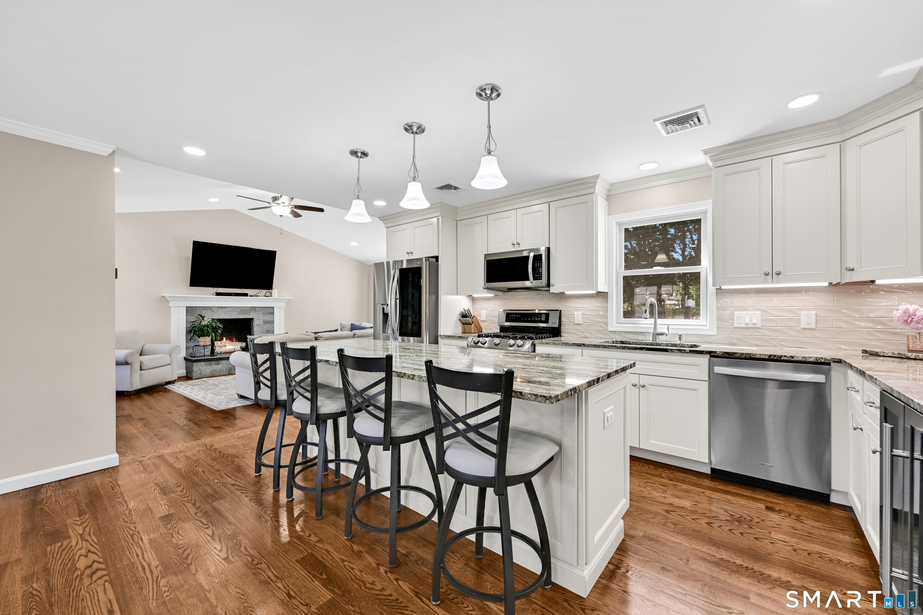 87 Lydall Road Newington, CT 06111 - Photo 10 of 35 a kitchen with stainless steel appliances a dining table chairs microwave and sink