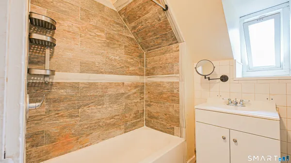 a bathroom with a bathtub and a shower