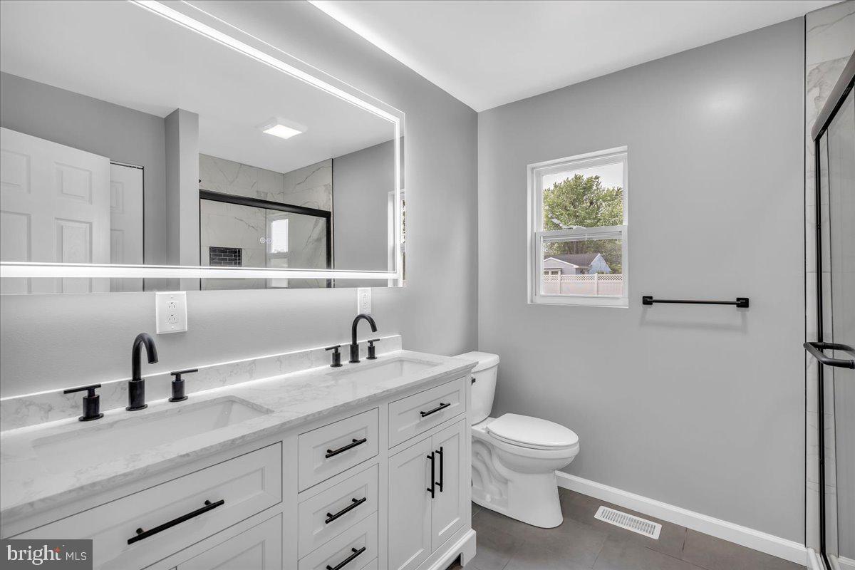 147 Country Club Road Pine Hill, NJ 08021 - Photo 22 of 53 a bathroom with a toilet a sink a mirror and a window