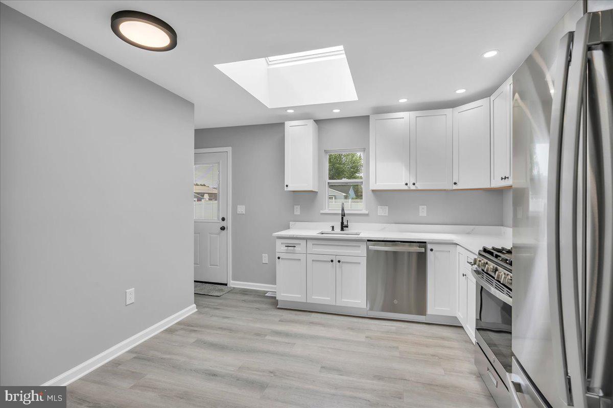 147 Country Club Road Pine Hill, NJ 08021 - Photo 23 of 53 a kitchen with a sink stainless steel appliances and cabinets