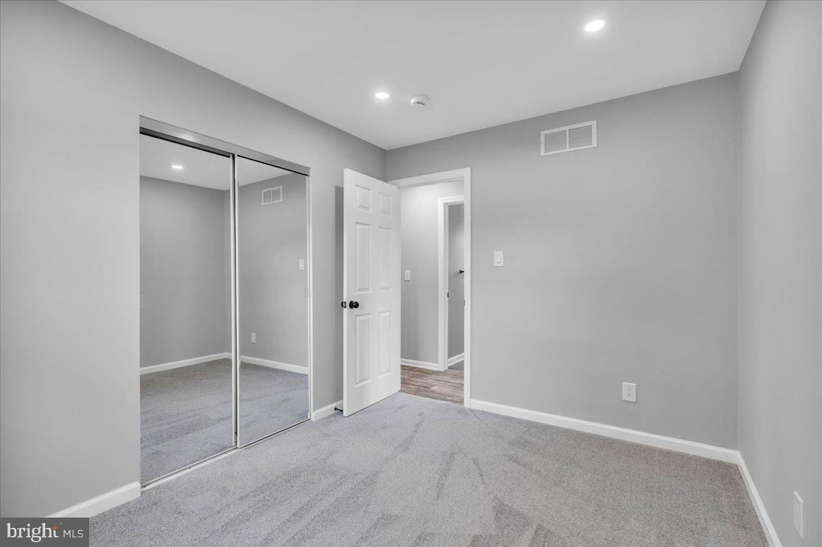 147 Country Club Road Pine Hill, NJ 08021 - Photo 27 of 53 an empty room with closet and wooden door